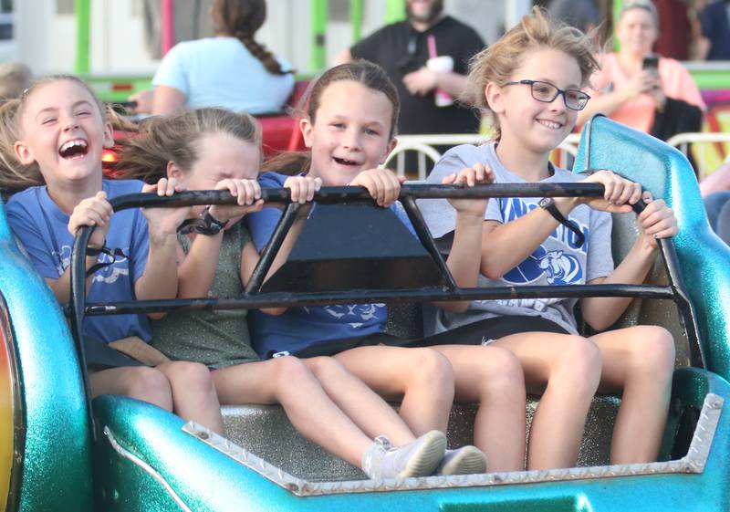 (From left) Tennyson Sayler, Jenna McNabb, Nora McNabb, 
Tessa Sayler react while riding the "Scrambler" carnival ride during the 169th Bureau County Fair on Thursday, Aug. 22, 2024 in Princeton.