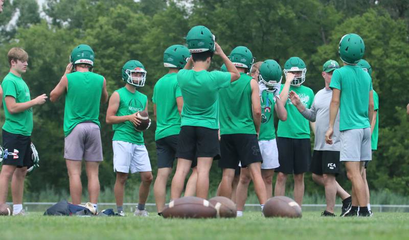Members of the Seneca football team huddle during a 7-on-7 meet against L-P on Wednesday, July 10, 2024 at Seneca High School.