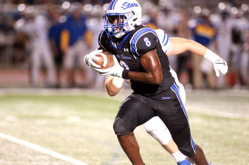 St. Charles North’s Joell Holloman runs the ball during a game against Wheaton North Friday, Sept. 13, 2024 at St. Charles North.