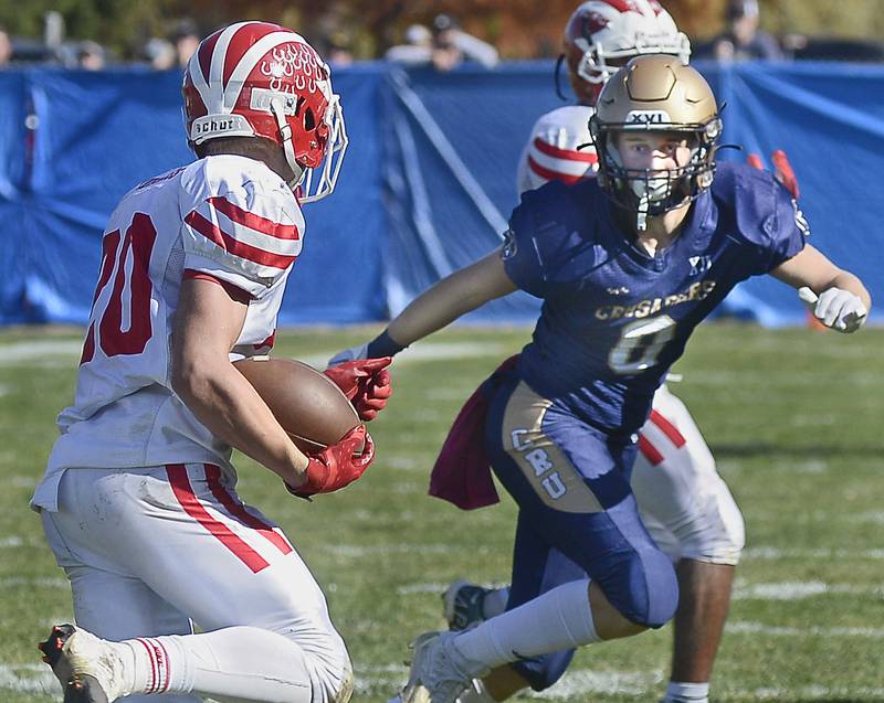 Marquette’s Griffen Walker looks to bring down Morrison’s Brady Anderson on a run in the 1st quarter during the Class 1A first round playoff game on Saturday, Oct. 29, 2022 at Gould Stadium in Ottawa.