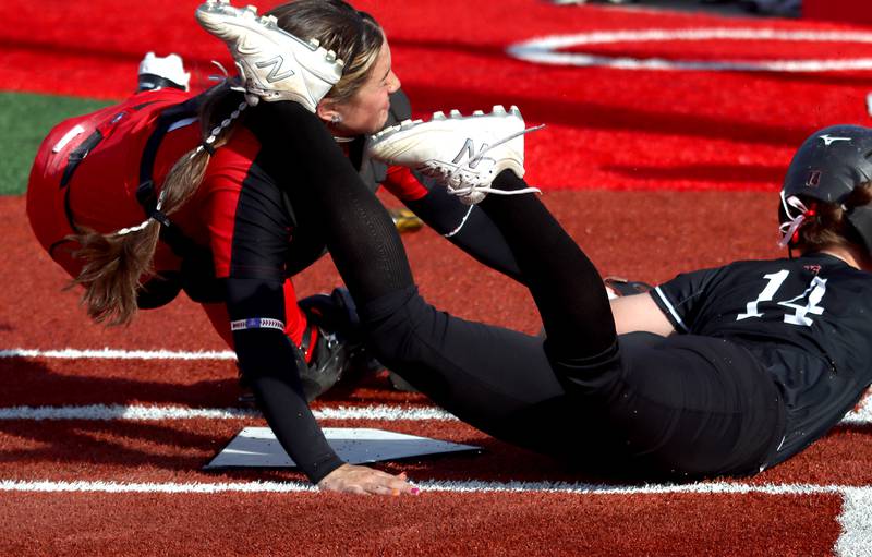 Huntley’s Madison Rozanski, right, is safe at home as he cleat catches Barrington catcher Emma Kavanagh in the head in sectional final softball  action at Barrington Friday.