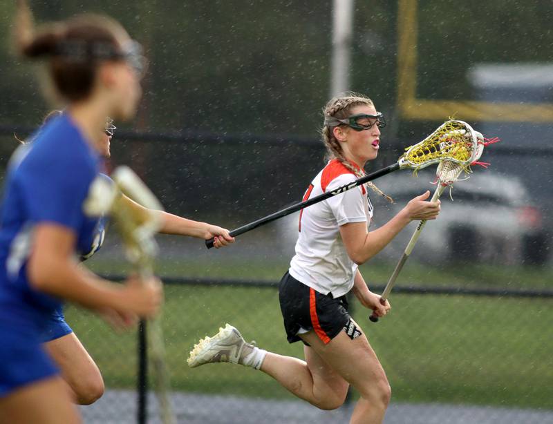 Crystal Lake Central’s Ella Trudeau moves the ball against  Lake Forest during girls lacrosse supersectional action at Metcalf Field on the campus of Crystal Lake Central Tuesday.