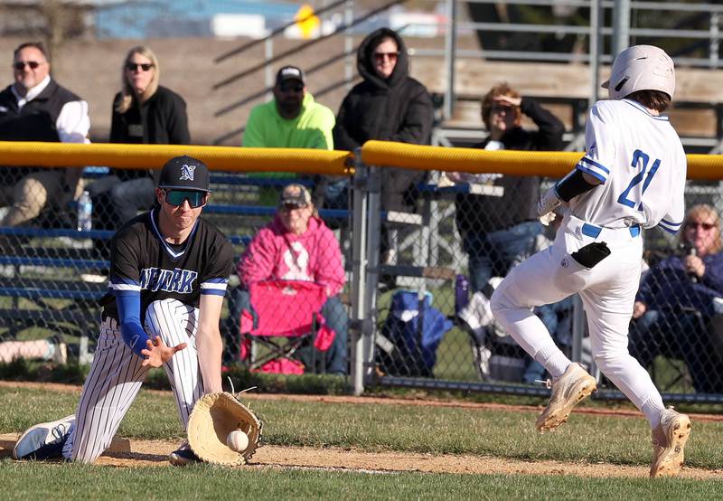 Newark's Payton Wills tries to pick the ball out of the dirt as Hinckley-Big Rock’s Joe Bazan hustles down the line Monday, April 8, 2024, during their game at Hinckley-Big Rock High School.