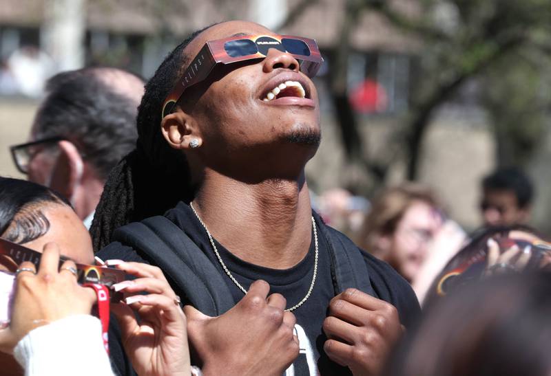 Attendees watch the eclipse Monday, April 8, 2024, at the Northern Illinois University Solar Eclipse Viewing Party behind Davis Hall in DeKalb. Attendees were treated to perfect weather to watch the rare celestial event.