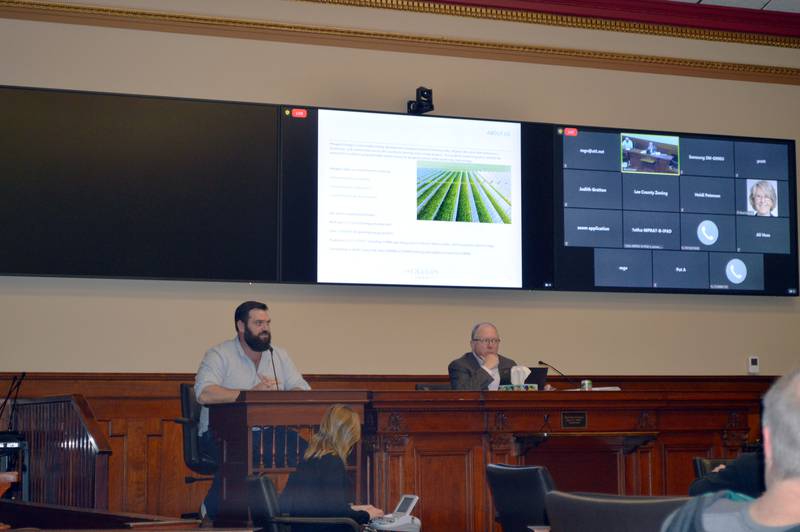 Hexagon Energy Senior Director of Development Scott Remer, left, provides sworn testimony during a Feb. 22, 2024, Lee County Zoning Board of Appeals public hearing regarding Phase 2 of the proposed 1,200-megawatt Steward Creek solar facility.