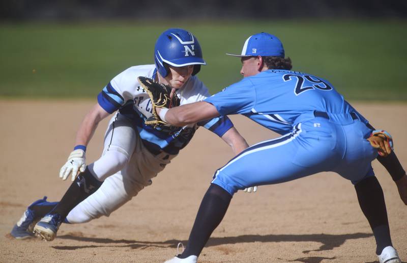 After multiple pickoff attempts, Lake Park's Jacob Folkes (29) was able to lay down a tag to get St. Charles North's Jackson Spring out at first during Friday’s baseball game in St. Charles.