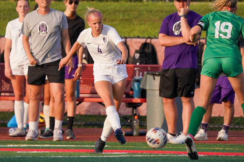 Downers Grove North's Annika Issacson (4) plays the ball against York’s Ava Hansmann (19) during a Class 3A Hinsdale Central Sectional semifinal soccer match at Hinsdale Central High School in Hinsdale on Tuesday, May 21, 2024.