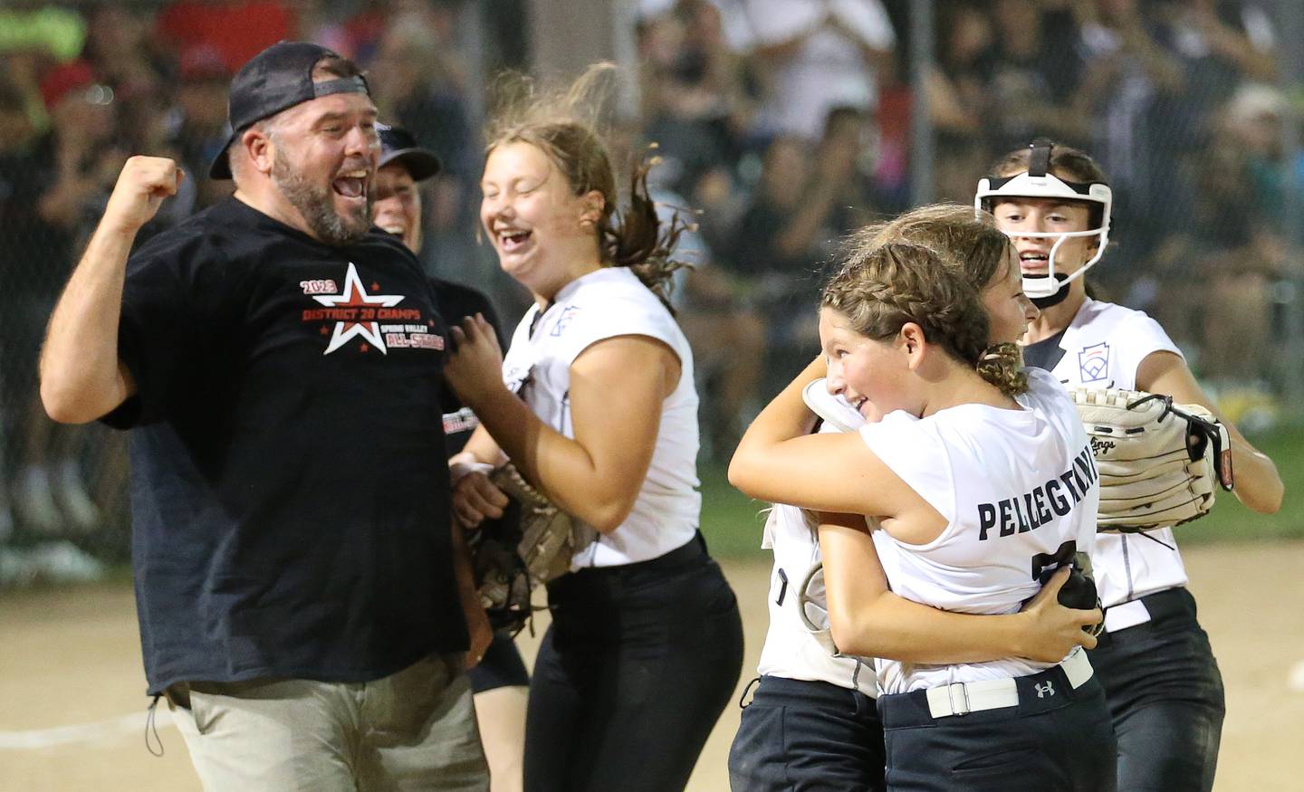 (From left) Spring Valley head softball coach Josh Pellegrini, players Stella Simpson, Vivi Verucchi, Brynn Pellegrini, and Reese Baltikauski celebrate on the mound after defeating Evergreen Park 5-1 in the Minor League Softball State title game on Thursday, July 27, 2023 at St. Mary's Park in La Salle.