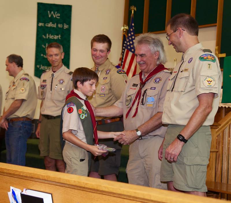 Liam Stern gets congratulated as he receives a merit badge during Boy Scout Troop 7’s 100th Anniversary Celebration on Sunday, Sept. 15, 2024 at the Community Congregational Church in Elburn.