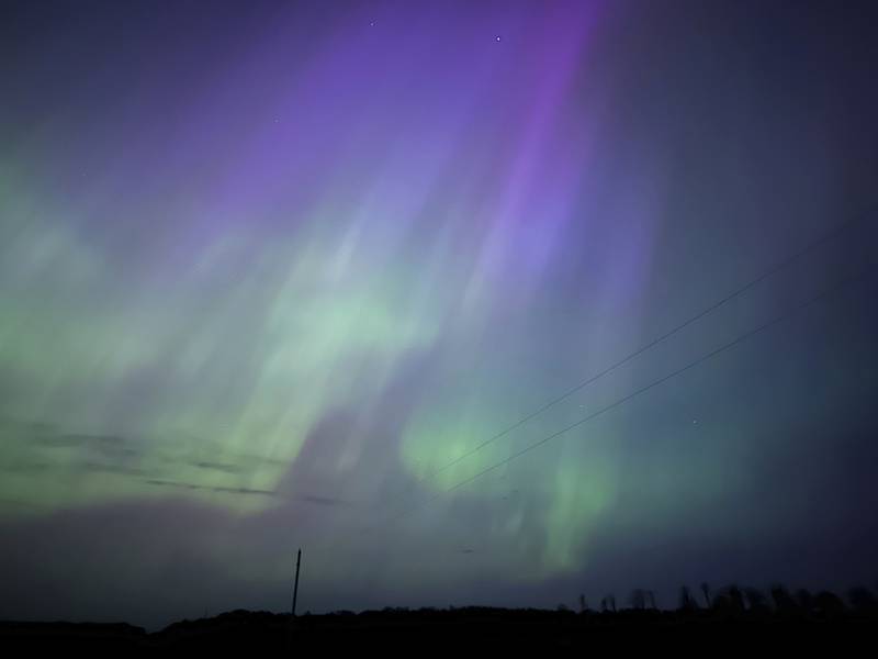 Northern lights glow in the sky near Kroschel, Minn., late Friday, May 10, 2024. (Owen Caputo Sullivan via AP)