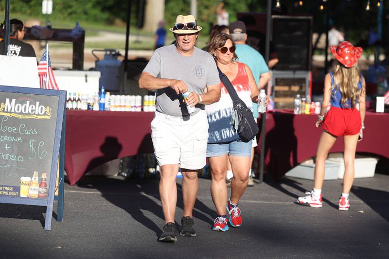Don and Denise Salvino grab drinks while taking in the live music at Dellwood Park in Lockport on Wednesday July 3, 2024.