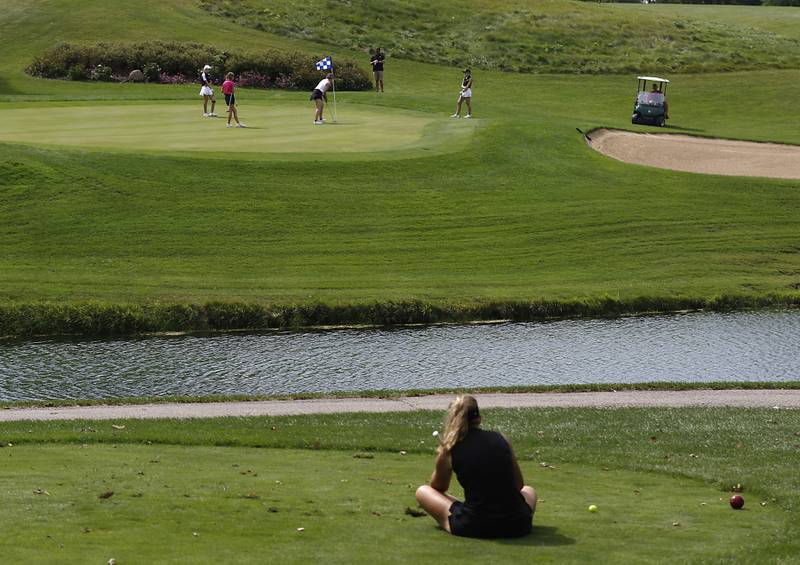 McHenry’s Madison Donovan waits for the group ahead of her to finish putting on the 13th green during the Fox Valley Conference Girls Golf Tournament Wednesday, Sept. 21, 2022, at Crystal Woods Golf Club in Woodstock.