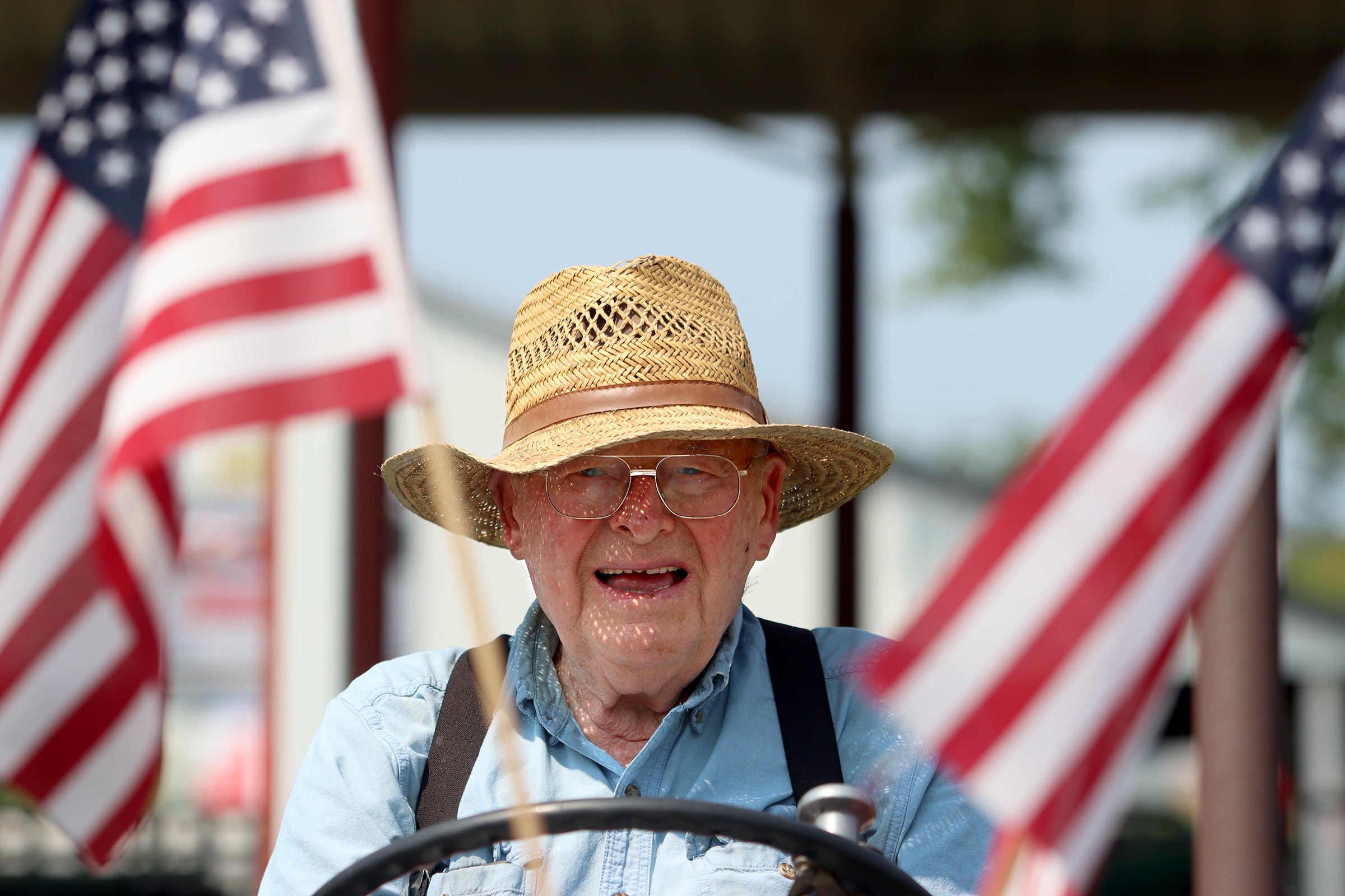 Marvin Marquardt of Marengo enjoys the view from his 1964 Ford 4000-series tractor at the McHenry County Fair in Woodstock on Tuesday, July 30, 2024.