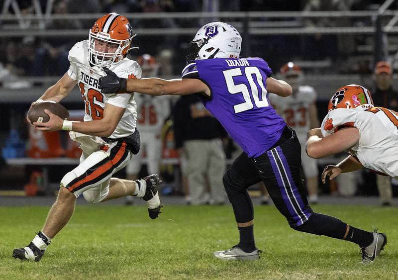 Byron QB Andrew Talbert scrambles against Dixon’s Aidan Howard Friday, Oct. 18, 2024, at A.C. Bowers Field in Dixon.