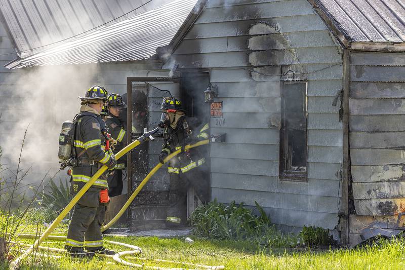 Firefighters work at the scene of a house fire at 204 East 11th Street in Rock Falls Wednesday, May 1, 2024. Neighbors heard an explosion prior to the house fire on the State Fire Marshal is investigating.