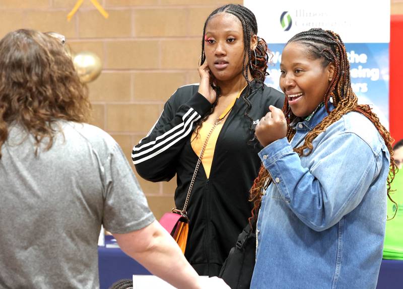 Lailaa Shakir (right) and her daughter Zahara, 16, from DeKalb, stop at a booth during the DeKalb Chamber of Commerce’s Local Showcase and Job Fair Thursday, April 25, 2024, at the DeKalb Sports and Recreation Center.