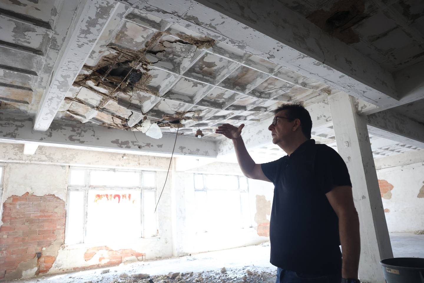 Ron Romero, executive director of the Illinois Rock & Roll Museum on Route 66, shows the damage that was done to the roof of the museum by the storm on July 14th, 2024.