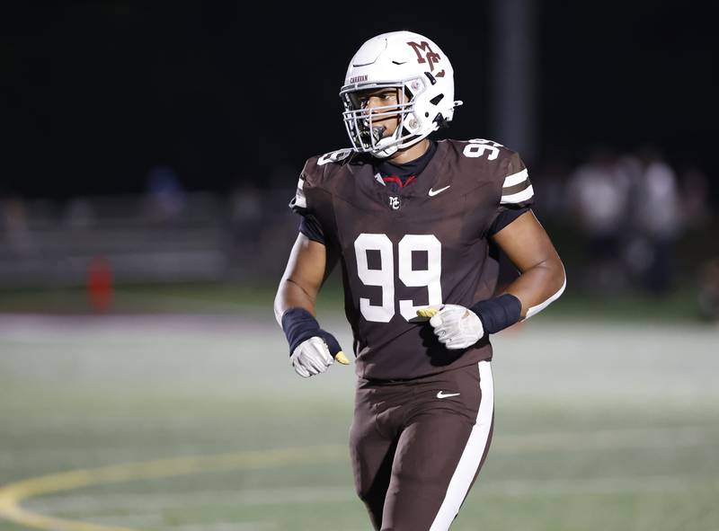 Mt. Carmel's Braeden Jones (99) runs off the field during the varsity football game between Nazareth Academy and Mt. Carmel high school on Friday, Sep. 13, 2024 in Chicago.