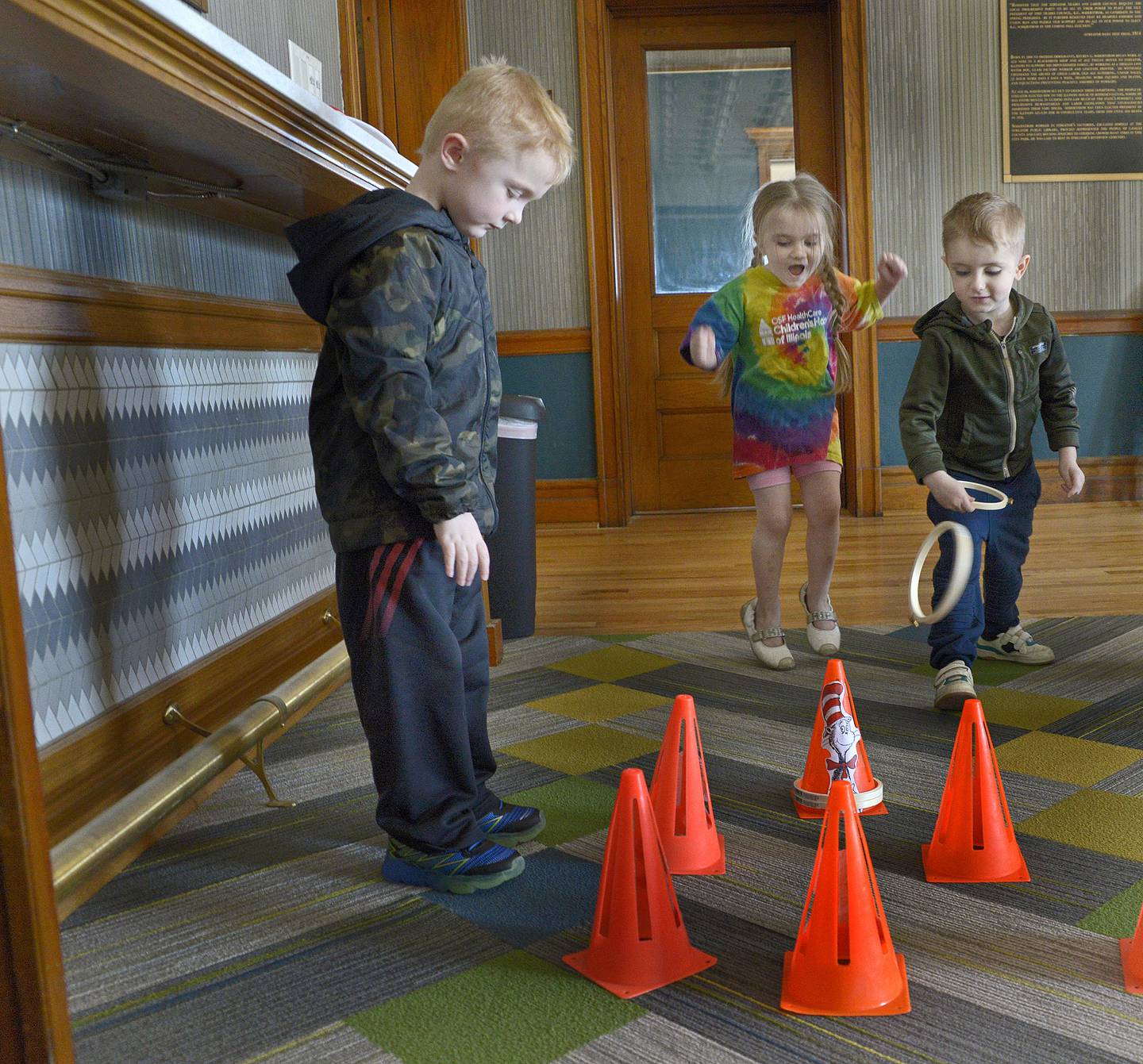 Children play a Cat In The Hat themed ring toss game Saturday, March 2, 2024, at the Streator Public Library. A Seussical Celebration was held to commemorate the birthday of Dr Seuss.