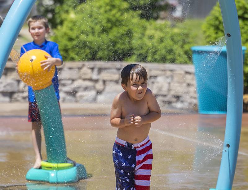 Max Rosquist, 5, of Polo reacts to the cooling spray of water Wednesday, June 12, 2024 at the Dixon splash pad.