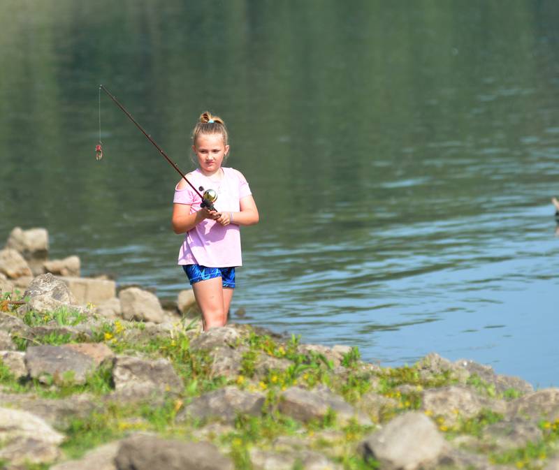 Breslyn Reynolds, 10, of Chadwick, gets ready to cast her line as she fishes at the 17th Dick Brown Fishing Derby for kids at Prophetstown State Park on Saturday, June 17.