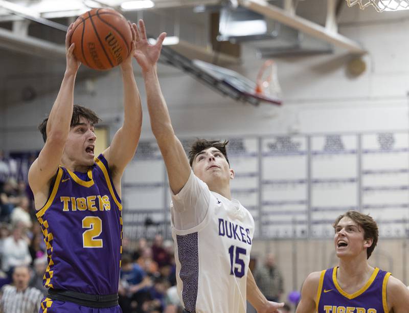 Sherrard’s Jack Hatlestad pulls down a rebound against Dixon’s Alex Harrison Thursday, Feb. 15, 2024 at Dixon High School.