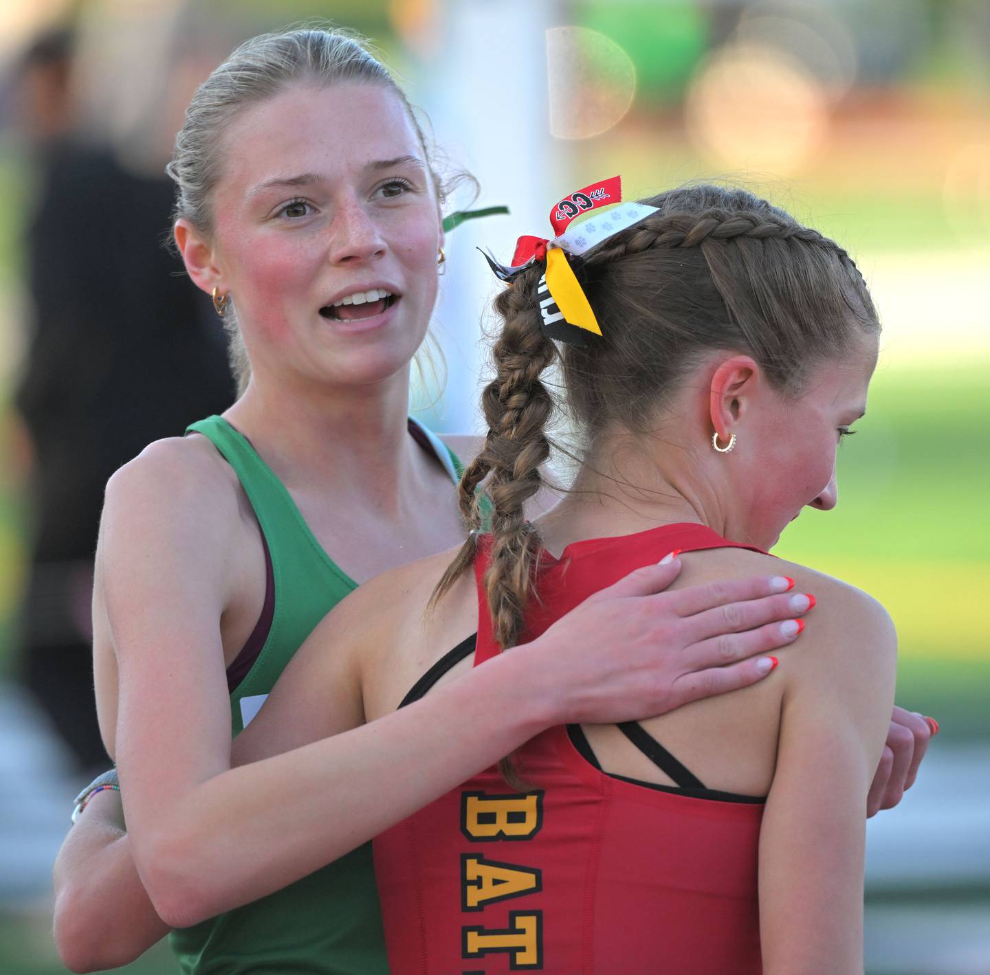 York’s Anna McGill congratulates Batavia’s Avery Hacker after they raced to a first and second place in the 3,200-meter run at the Lake Park Class 3A girls track and field sectional meet on Friday, May 10, 2024.