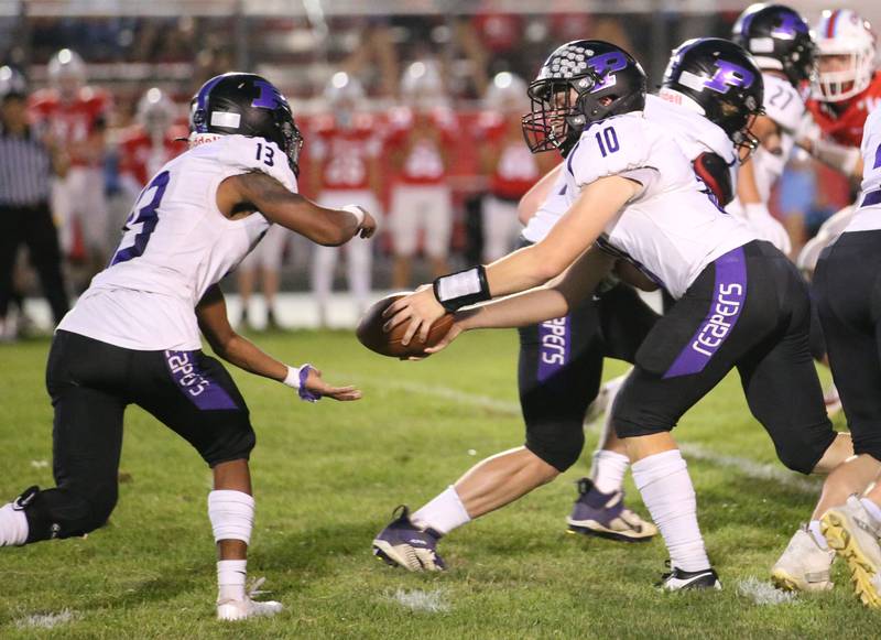 Plano quarterback Kaiden Schimandle hands the ball off to Amari Bryant on Friday, Aug. 30, 2024 at King Field.