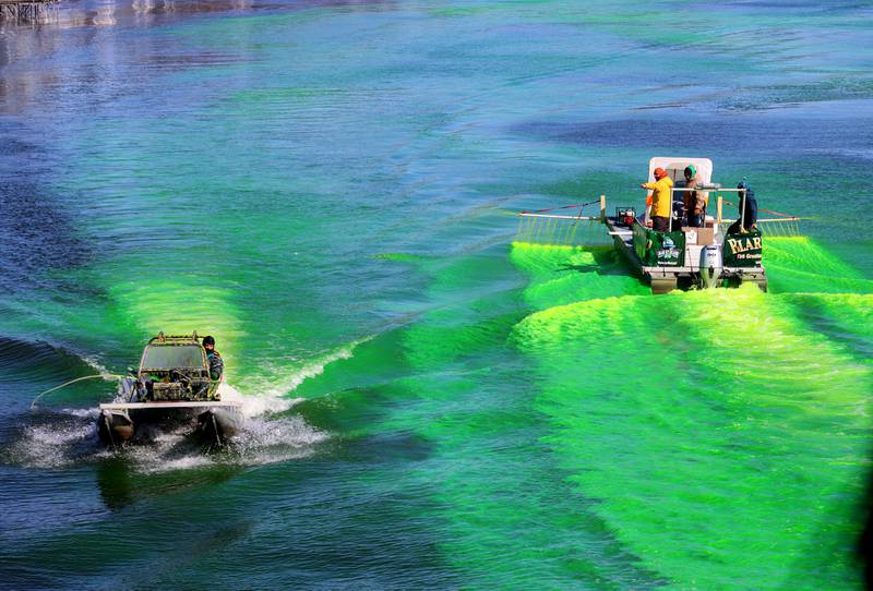 Crews dump dye into the Fox River near the Pearl Street Bridge during the ShamROCKS the Fox festival in McHenry on Saturday, March 12, 2022.