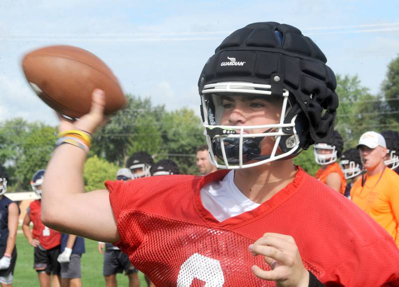 Oswego quarterback candidate Brogan Mello throws a pass during football practice at Oswego High School on Monday, Aug 7, 2023.