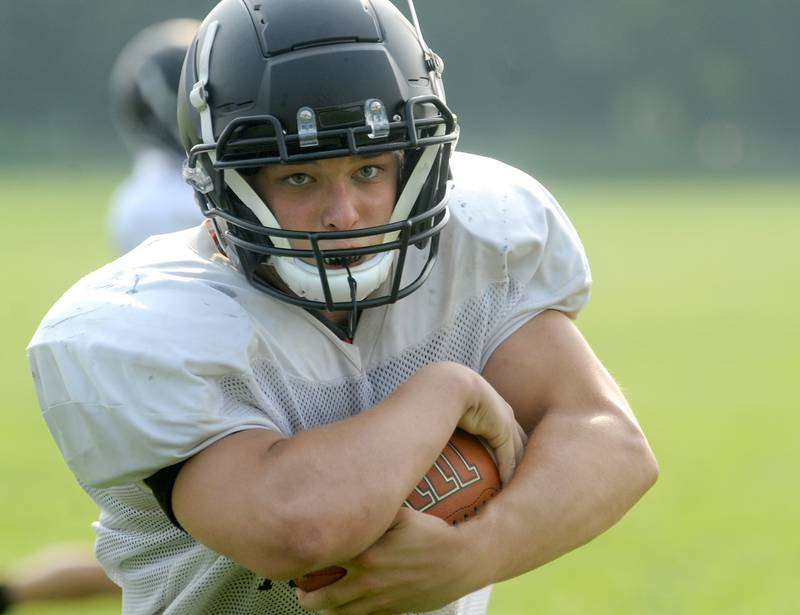 Sandwich fullback Parker Anderson carries the ball up the middle during early summer football practice at Sandwich High School on Monday, July 17, 2023.