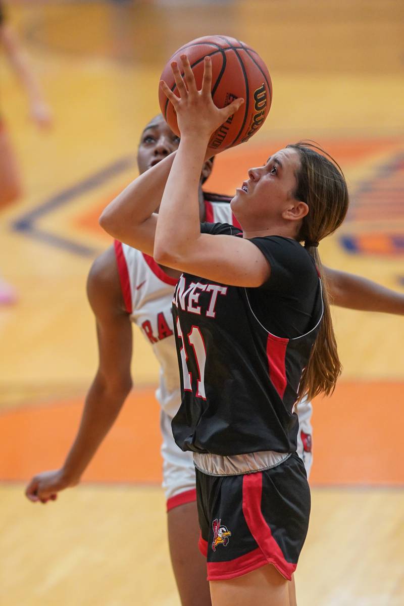 Benet’s Ava Mersinger (21) shoots the ball in the post against Bolingbrook's Trinity Jones (10) during a Oswego semifinal sectional 4A basketball game at Oswego High School on Tuesday, Feb 20, 2024.