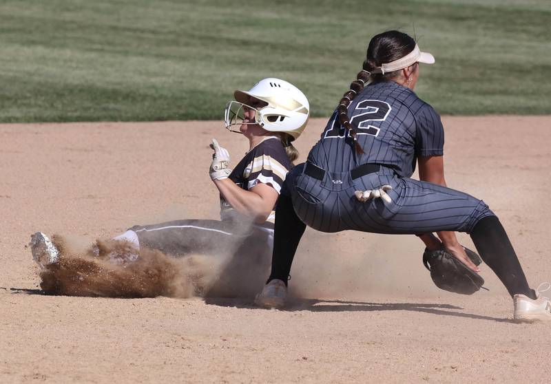 Sycamore's Addison McLaughlin slides in with a stolen base behind Kaneland's Angelina Campise during their Class 3A sectional semifinal Thursday, May 30, 2024, at Sycamore High School.