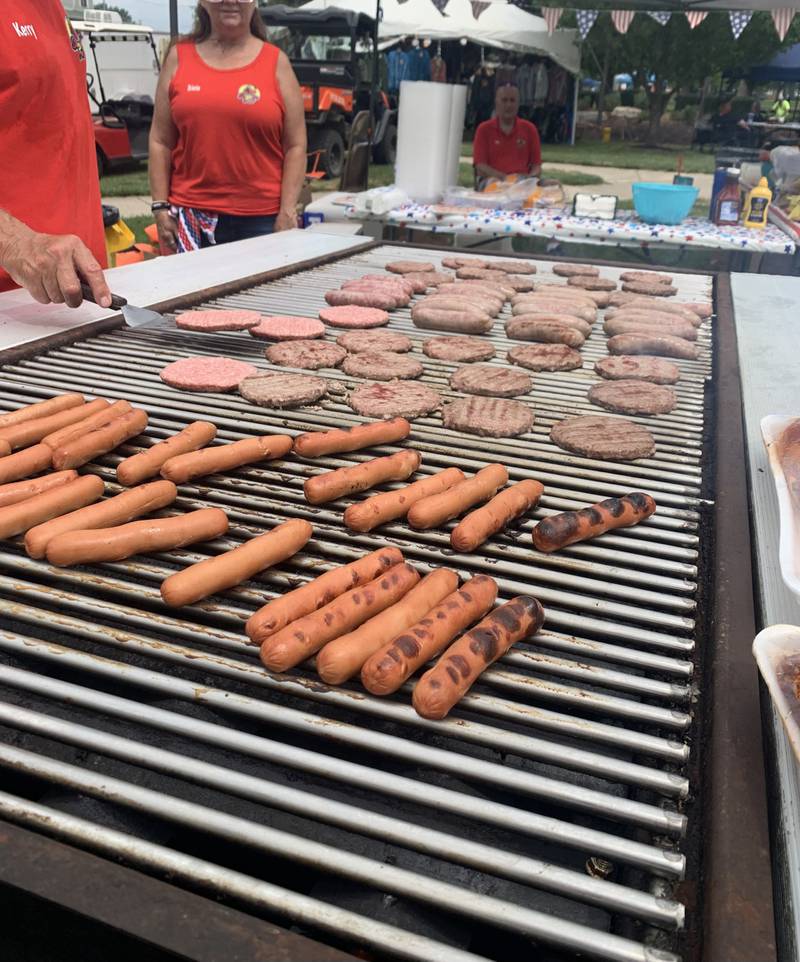 Liberty Fest staff does a cookout with hot dogs, burgers and bratwurst in Streator on Saturday June 29, 2024. (Bill Freskos)
