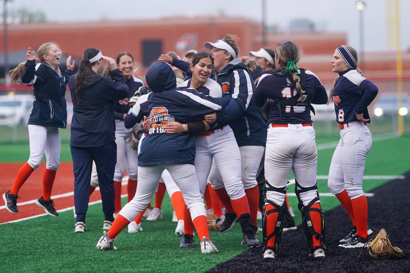 Oswego players celebrate after defeating Yorkville in a softball game at Yorkville High School on Thursday, May 9, 2024.