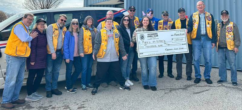 Sycamore Lions Club members donating $1,000 to Meals on Wheels