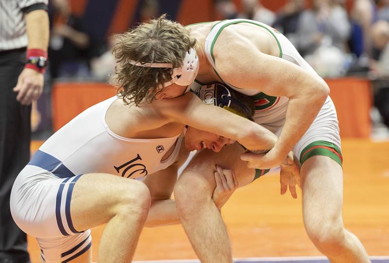 IC Catholic’s Joe Gliatta gets low on Lincoln’s Dawson McConnell in the 165 pound third place 2A match Saturday, Feb. 17, 2024 at the IHSA state wrestling finals at the State Farm Center in Champaign.