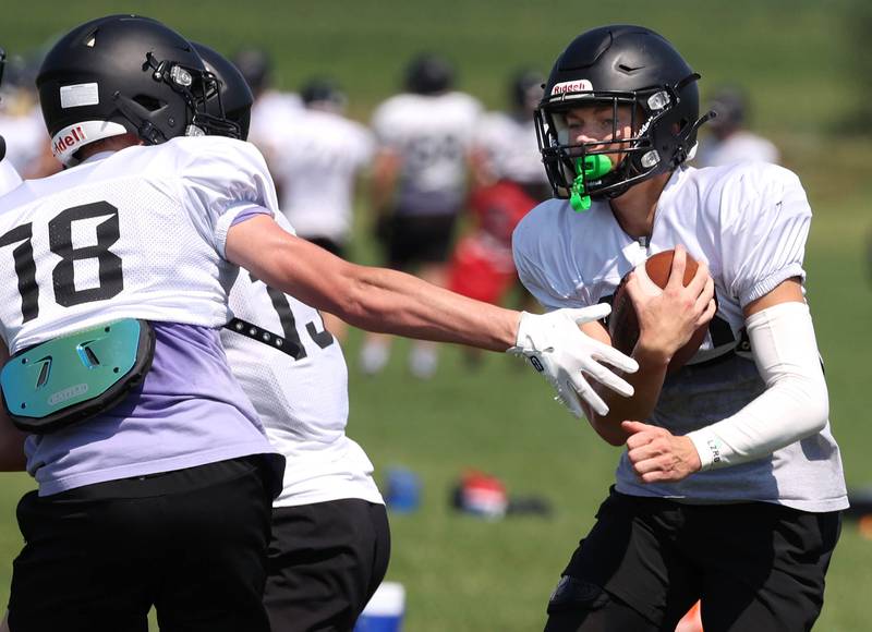 Sycamore’s Dylan Hodges runs the ball past an outstretched defender Monday, July 15, 2024, during summer football camp at Sycamore High School.