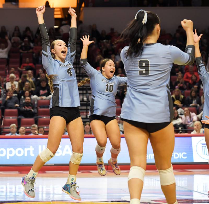 Willowbrook’s Eliza Ramey and Lily Javier react with teammates after defeating Barrington in the Class 4A girls volleyball state third-place match at Illinois State University in Normal on Saturday, October 11, 2023.