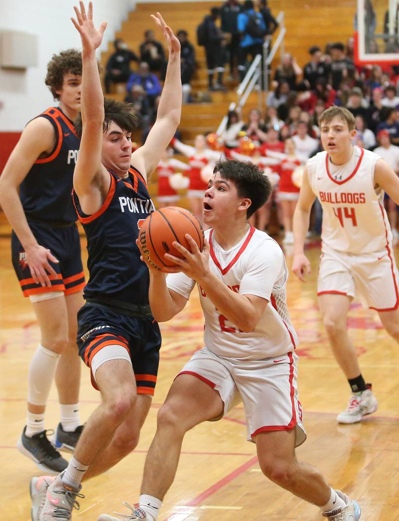 Streator's Logan Aukland eyes the hoop as Pontiac's Camden Fenton defends during the Class 3A Regional semifinal game on Wednesday, Feb. 22, 2024 at Pops Dale Gymnasium.