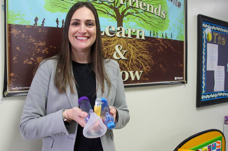 Christina Edwards, director of health services at District 202 in Plainfield, holds some of the undesignated quick relief asthma medication and related tools that trained staff at District 202 district can give to anyone in an emergency.