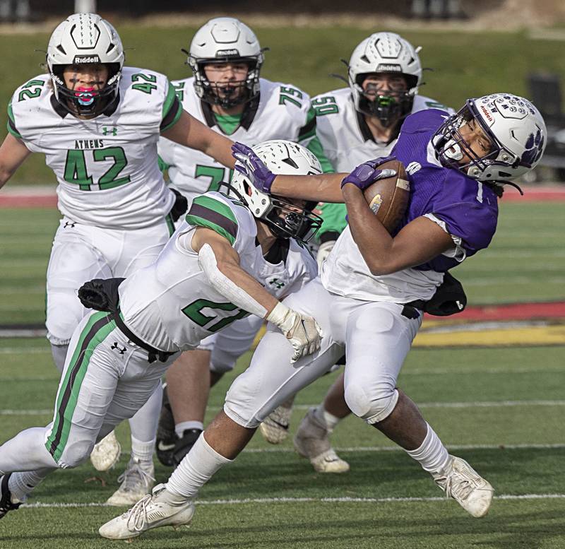 Wilmington's Kyle Farrell is hit hard by Athens’ Camren Bigard Friday, Nov. 24, 2023 in the 2A state football championship game at Hancock Stadium in Normal.