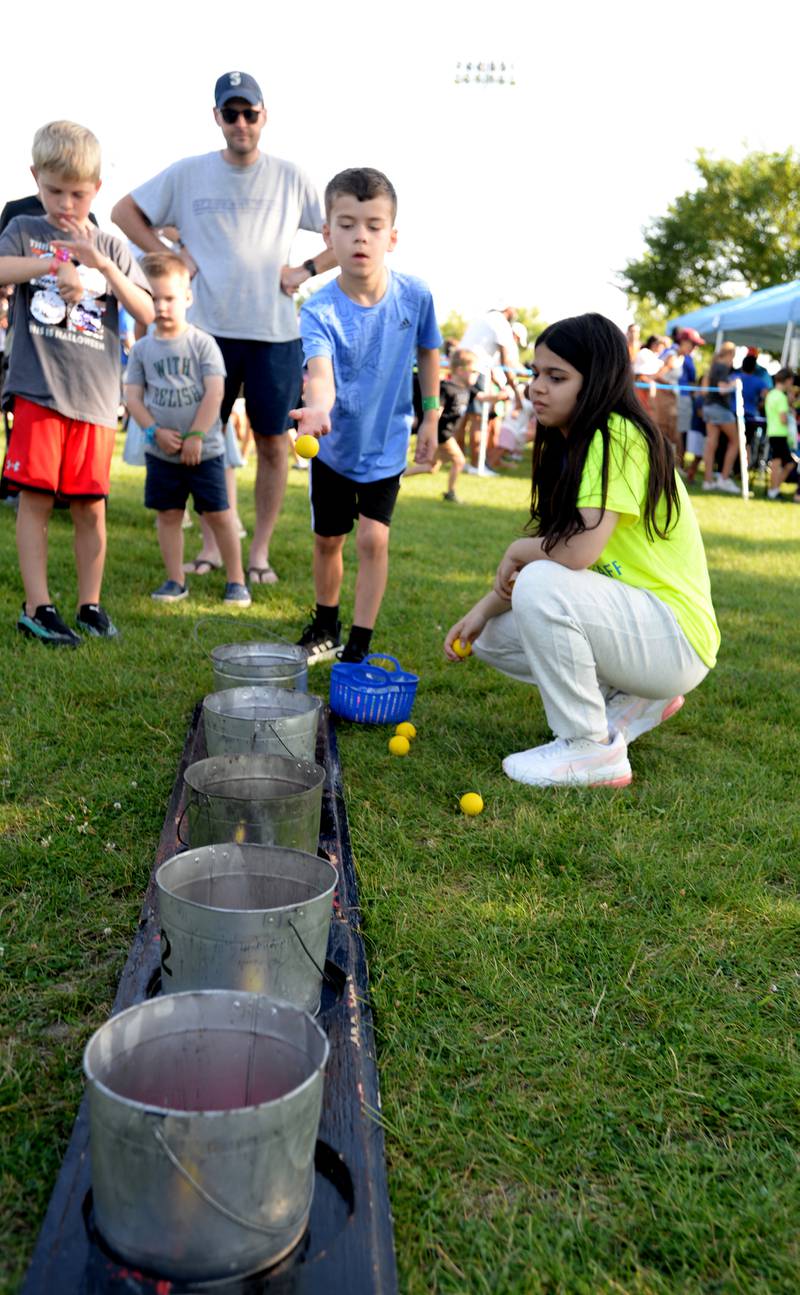 Children including Robby Coulton of Elmhurst enjoy the Bozo Buckets game while attending Park Palooza at Berens Park Saturday Aug 19, 2023.