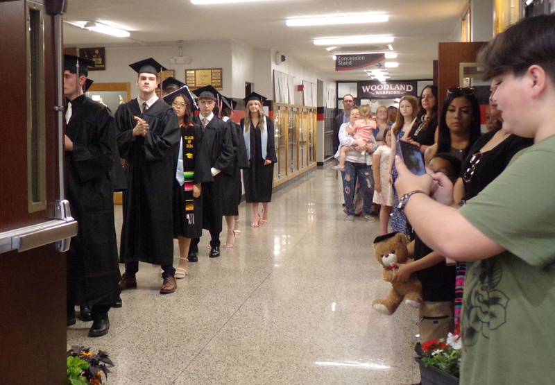 Woodland graduates line up in the hallway Sunday, May 19, 2024, to enter the graduation ceremony in the school's gymnasium.