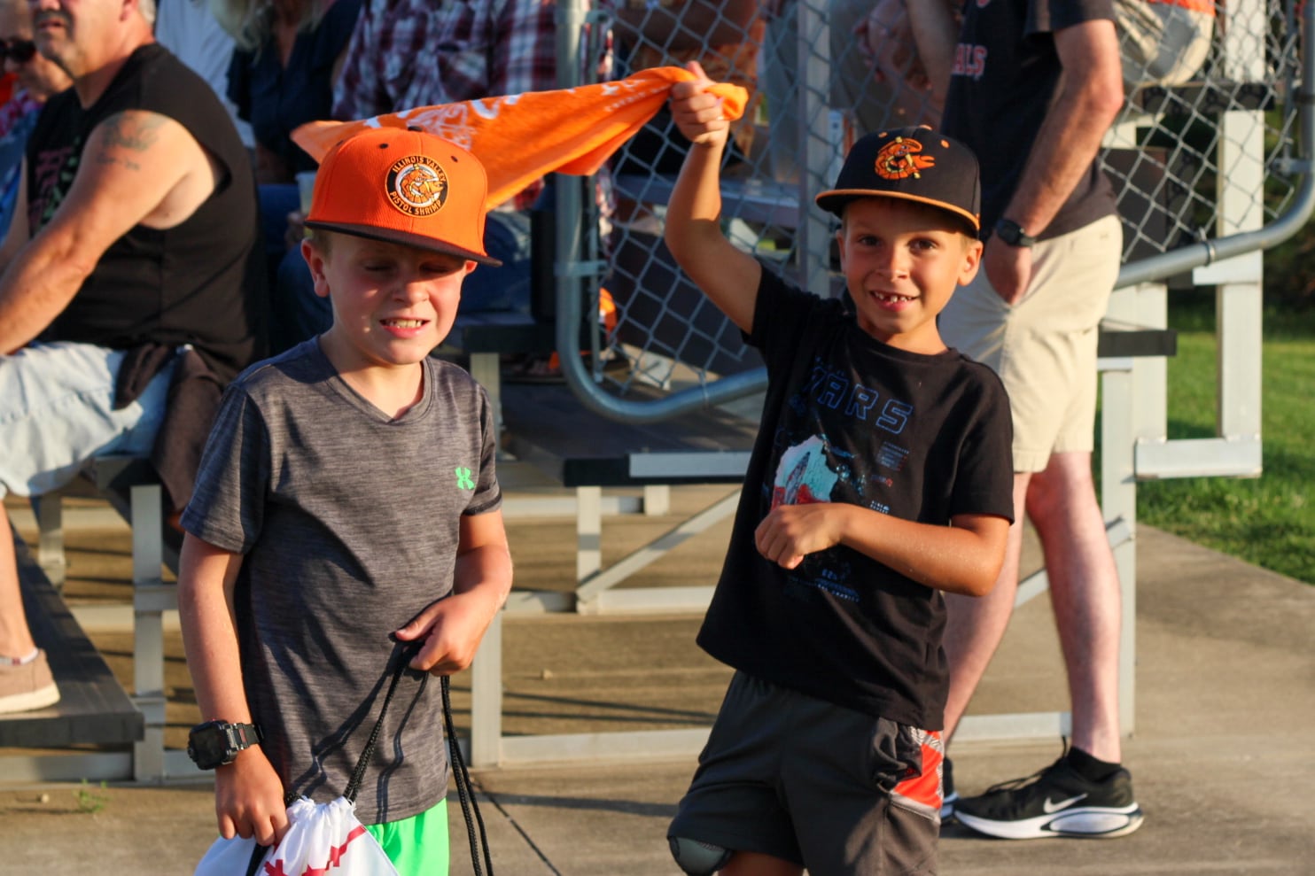 Young Illinois Valley Pistol Shrimp fans wave rally flags Thursday, Aug. 1, 2024, at Schweickert Stadium at Veterans Park in Peru.