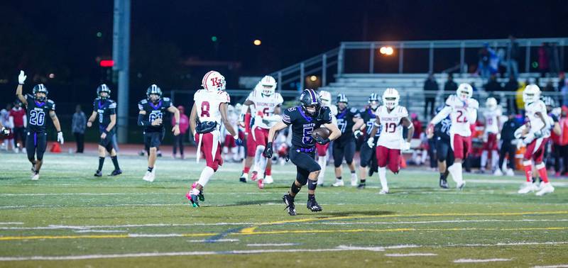 Downers Grove North's Owen Thulin (5) runs after the catch to score a touchdown against Kenwood during a class 7A playoff football game at Downers Grove North on Friday, Oct. 27, 2023.