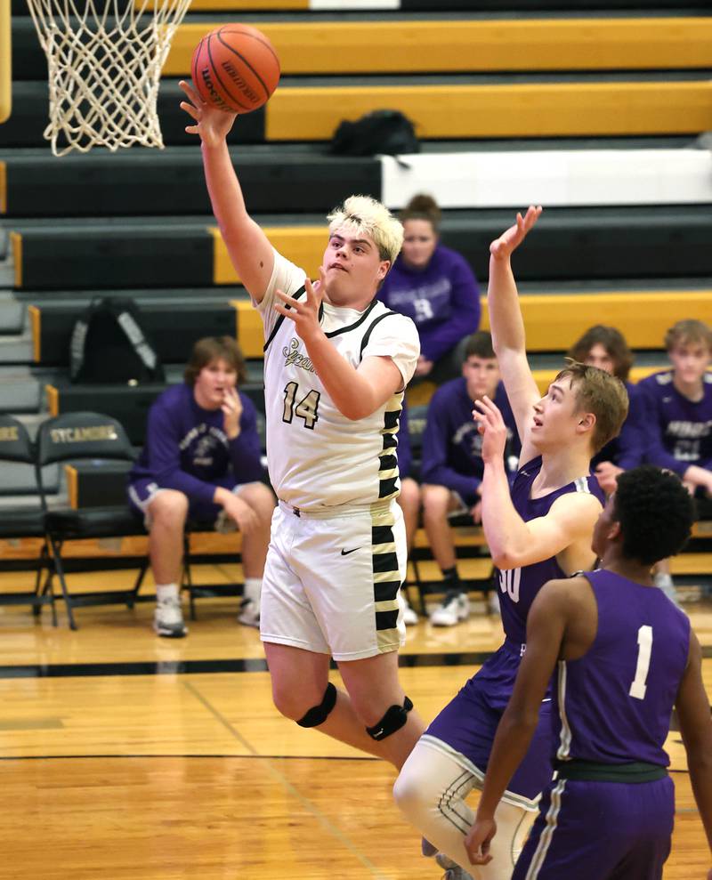 Sycamore's Michael Chami gets to the basket ahead of Rochelle's Eli Luxton during their game Tuesday, Dec. 5, 2023, at Sycamore High School.