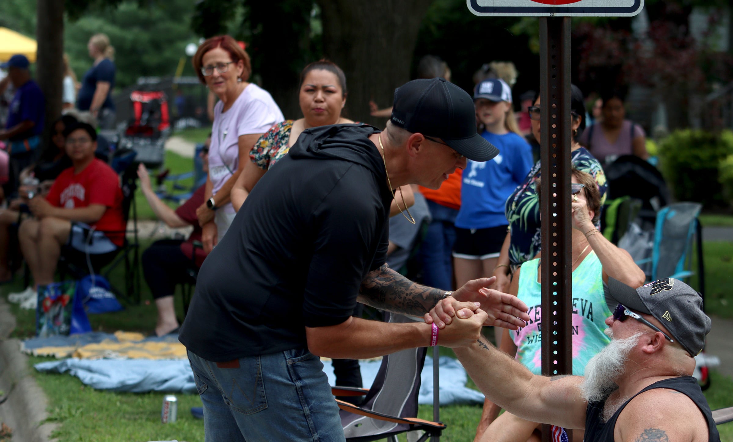 McHenry Mayor Wayne Jett greets people as he walks the route of the Fiesta Days parade along Main Street in McHenry Sunday.