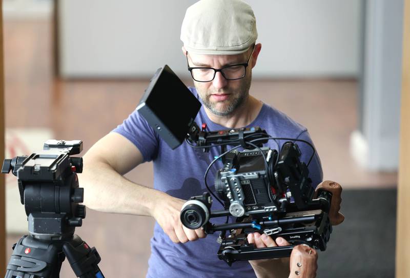 Seth Deming, with the group Write Film Edit and director for their latest project, sets up a camera for a shoot Thursday, May 16, 2024, in the studio at OC Creative in DeKalb.