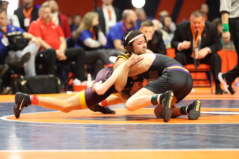 Montini’s Allen Woo works over Wauconda’s Gavin Rockey in the 106-pound Class 2A state championship match on Saturday, Feb. 17th, 2024 in Champaign.